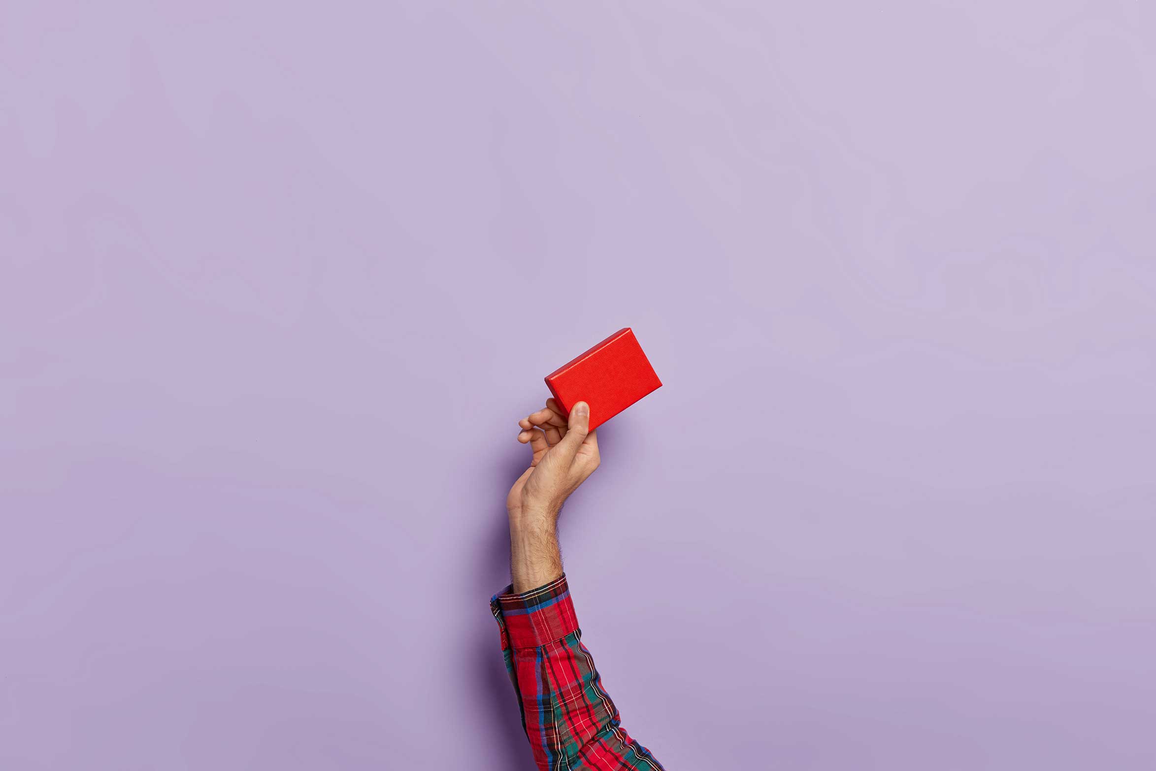 Man holding small book up in the air